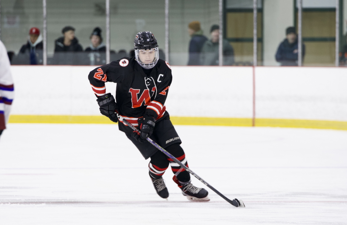 Charging up-ice with the puck, a Watertown senior captain Brendan Cummings cuts around a defender on his way into the offensive zone. 